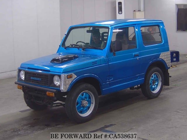 A grey JDM sports car speeding down a highway at night.