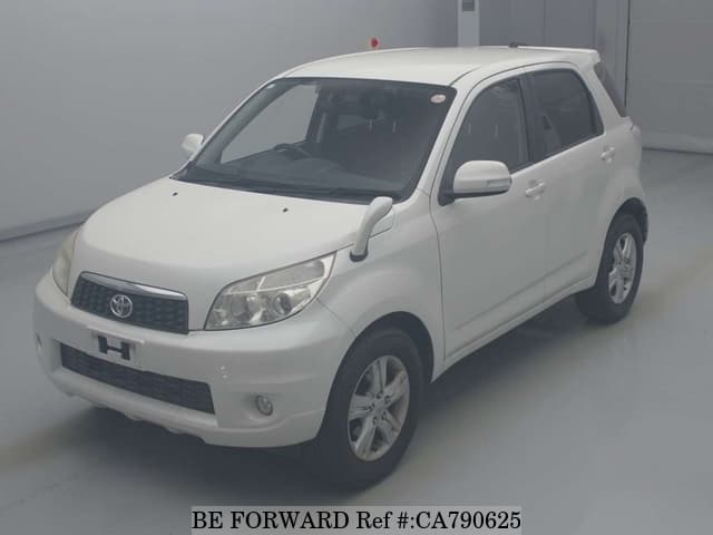 A grey JDM sports car speeding down a highway at night.