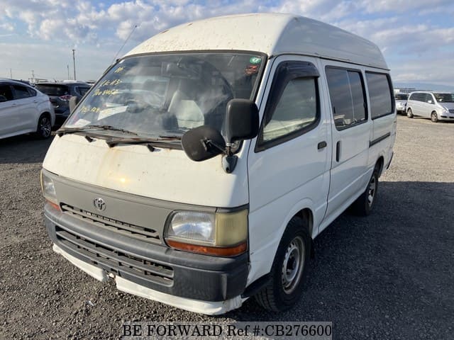 A grey JDM sports car speeding down a highway at night.