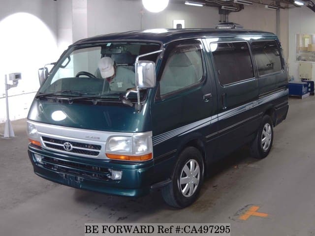 A grey JDM sports car speeding down a highway at night.