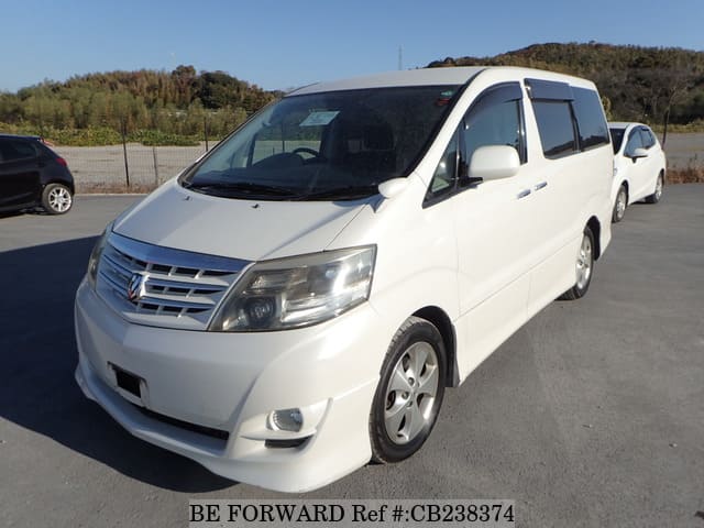 A grey JDM sports car speeding down a highway at night.