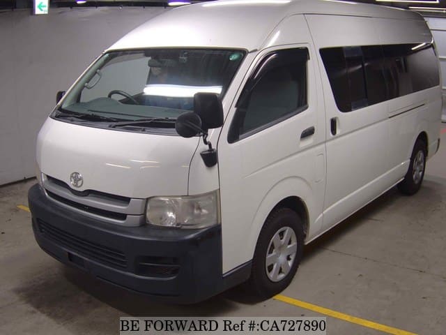 A grey JDM sports car speeding down a highway at night.