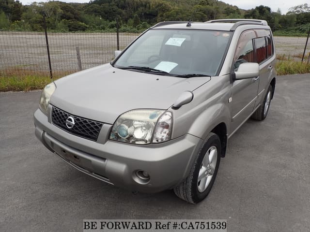 A grey JDM sports car speeding down a highway at night.