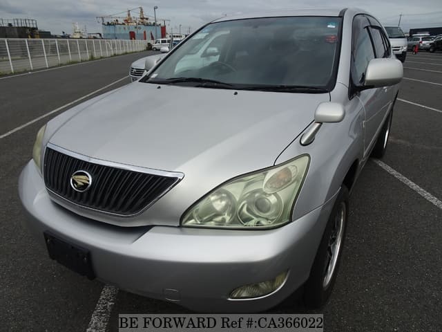 A grey JDM sports car speeding down a highway at night.