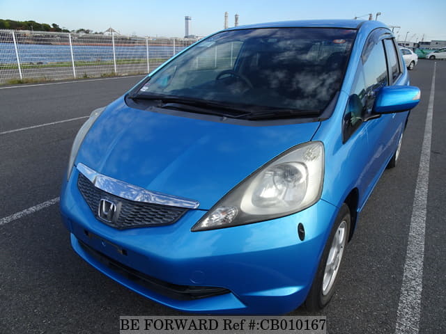 A grey JDM sports car speeding down a highway at night.