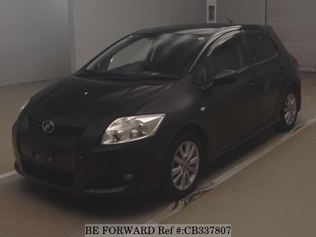 A grey JDM sports car speeding down a highway at night.