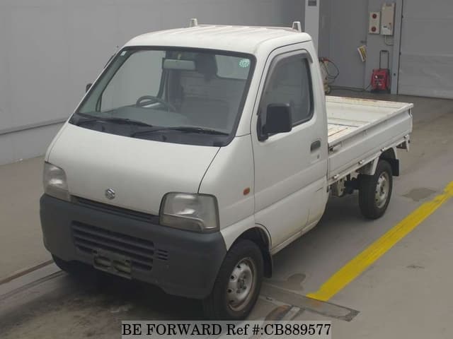 A grey JDM sports car speeding down a highway at night.