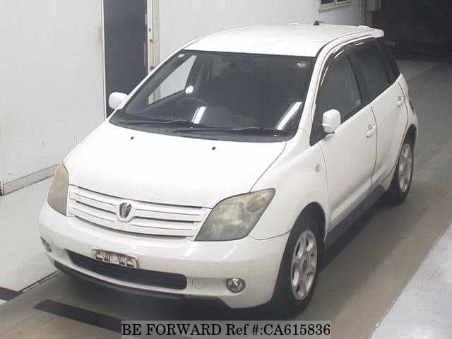 A grey JDM sports car speeding down a highway at night.