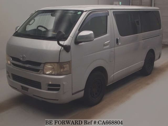 A grey JDM sports car speeding down a highway at night.