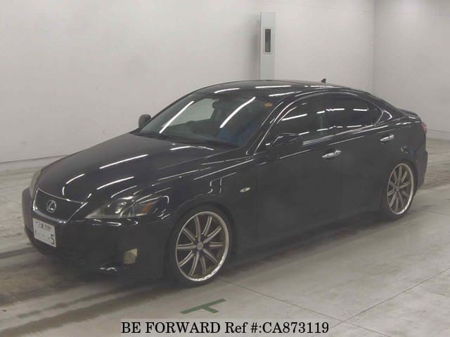 A grey JDM sports car speeding down a highway at night.