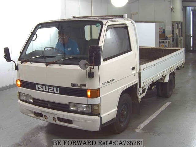 A grey JDM sports car speeding down a highway at night.