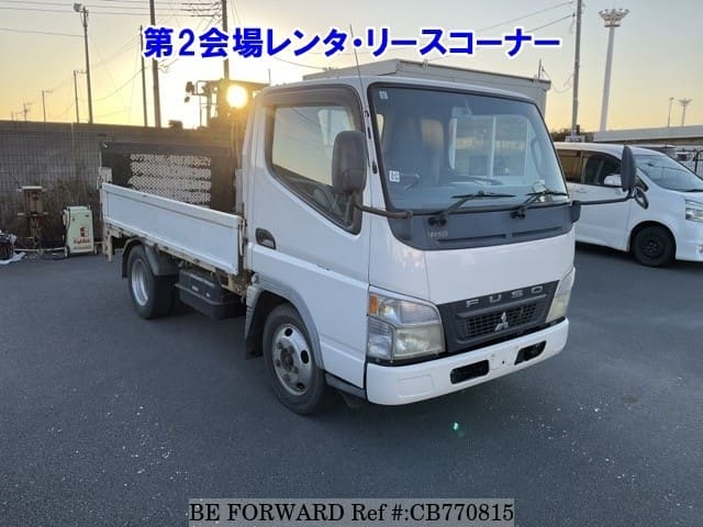A grey JDM sports car speeding down a highway at night.