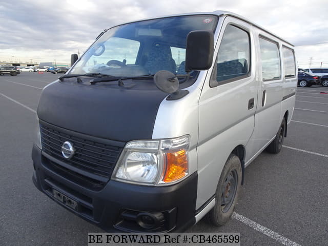 A grey JDM sports car speeding down a highway at night.