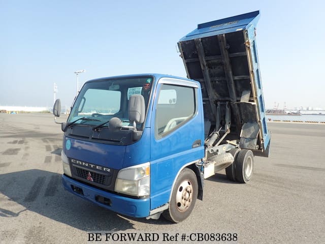 A grey JDM sports car speeding down a highway at night.