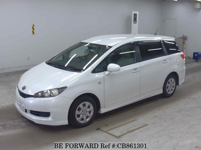 A grey JDM sports car speeding down a highway at night.