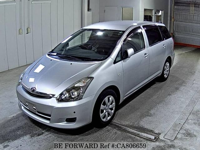 A grey JDM sports car speeding down a highway at night.