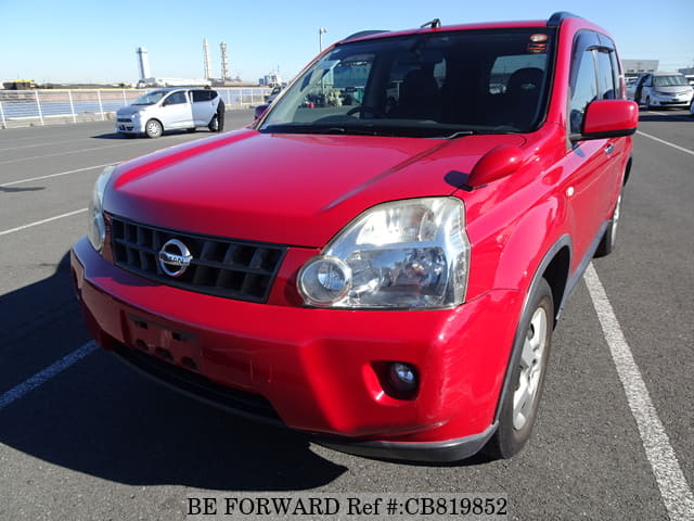 A grey JDM sports car speeding down a highway at night.