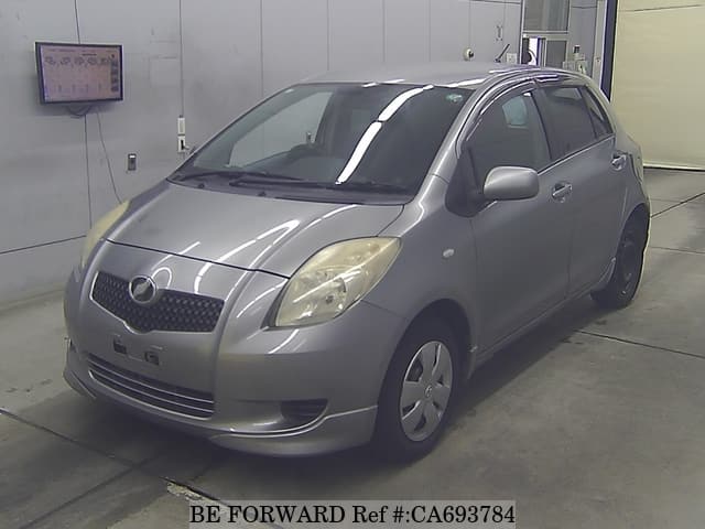 A grey JDM sports car speeding down a highway at night.