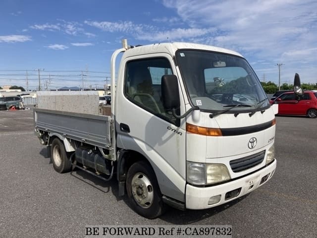 A grey JDM sports car speeding down a highway at night.