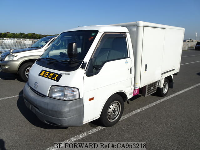 A grey JDM sports car speeding down a highway at night.