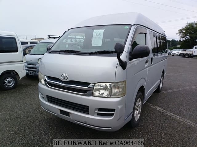 A grey JDM sports car speeding down a highway at night.