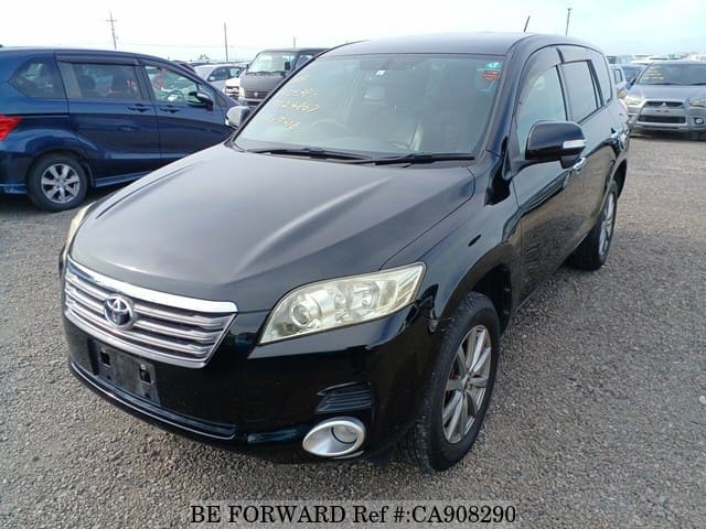 A grey JDM sports car speeding down a highway at night.