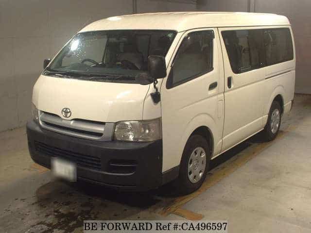 A grey JDM sports car speeding down a highway at night.