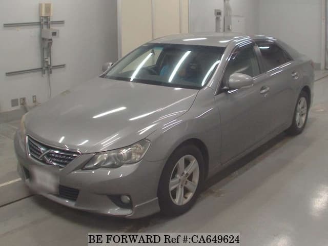 A grey JDM sports car speeding down a highway at night.