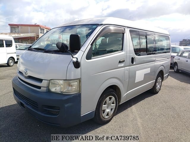 A grey JDM sports car speeding down a highway at night.