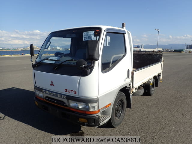 A grey JDM sports car speeding down a highway at night.