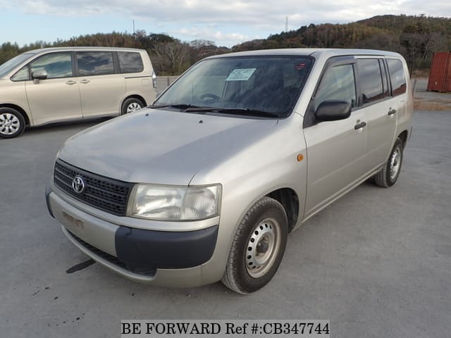 A grey JDM sports car speeding down a highway at night.
