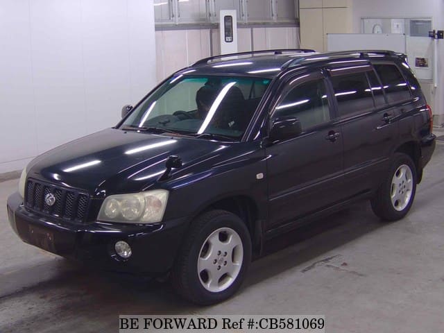 A grey JDM sports car speeding down a highway at night.