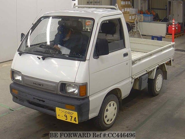A grey JDM sports car speeding down a highway at night.