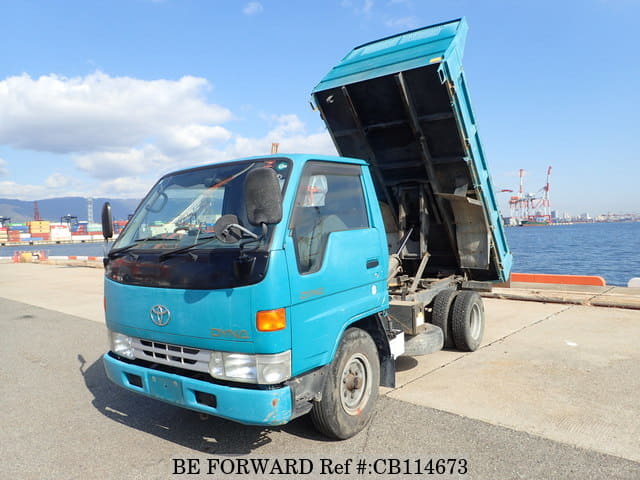 A grey JDM sports car speeding down a highway at night.