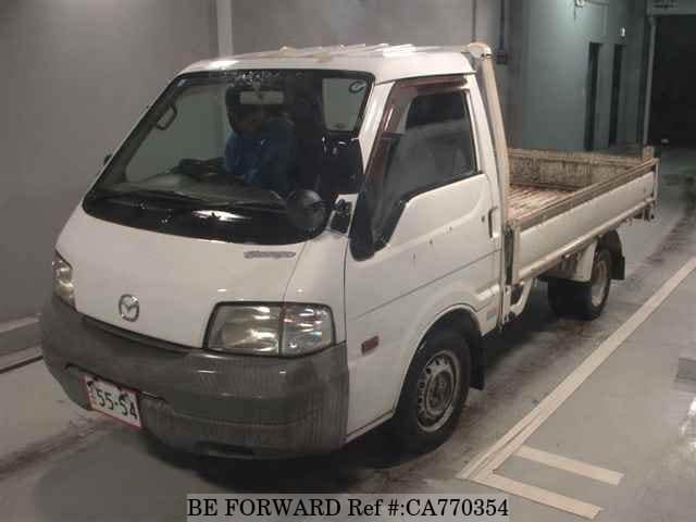 A grey JDM sports car speeding down a highway at night.