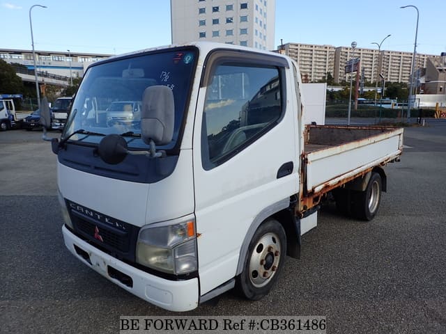 A grey JDM sports car speeding down a highway at night.