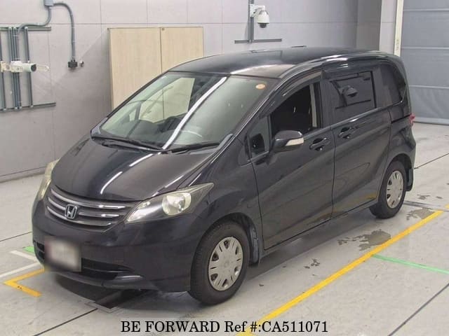 A grey JDM sports car speeding down a highway at night.
