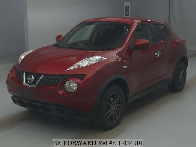 A grey JDM sports car speeding down a highway at night.