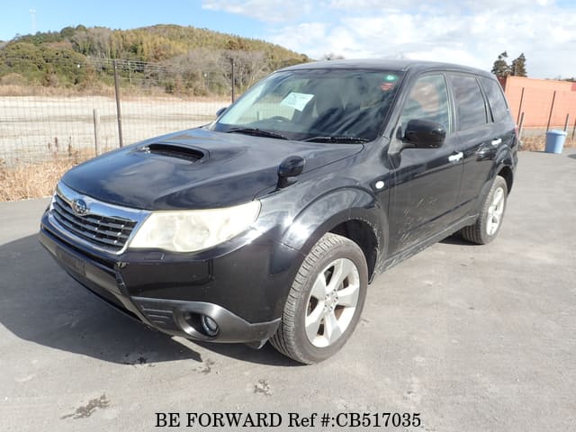 A grey JDM sports car speeding down a highway at night.