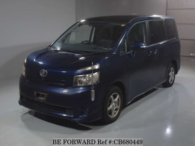 A grey JDM sports car speeding down a highway at night.