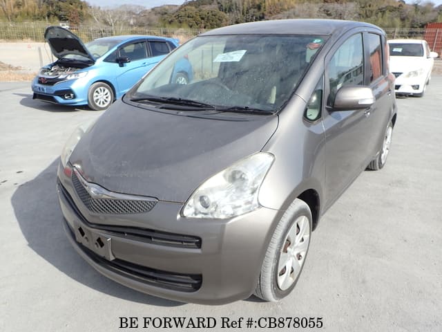 A grey JDM sports car speeding down a highway at night.