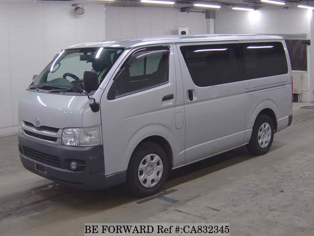 A grey JDM sports car speeding down a highway at night.