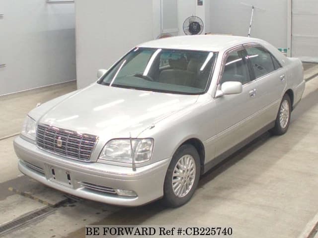A grey JDM sports car speeding down a highway at night.