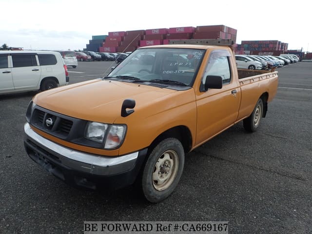 A grey JDM sports car speeding down a highway at night.