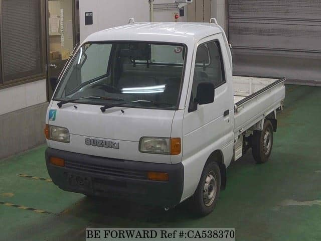 A grey JDM sports car speeding down a highway at night.