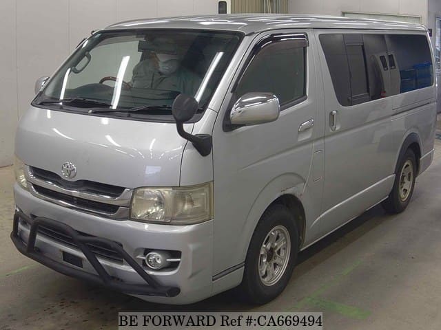 A grey JDM sports car speeding down a highway at night.