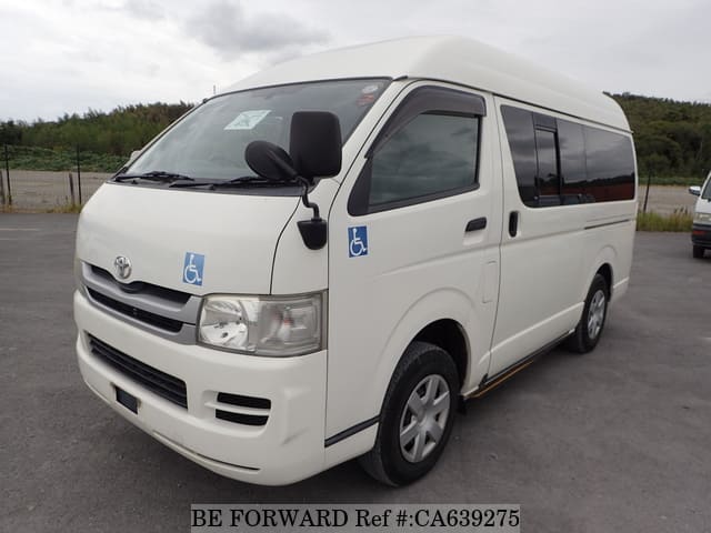 A grey JDM sports car speeding down a highway at night.