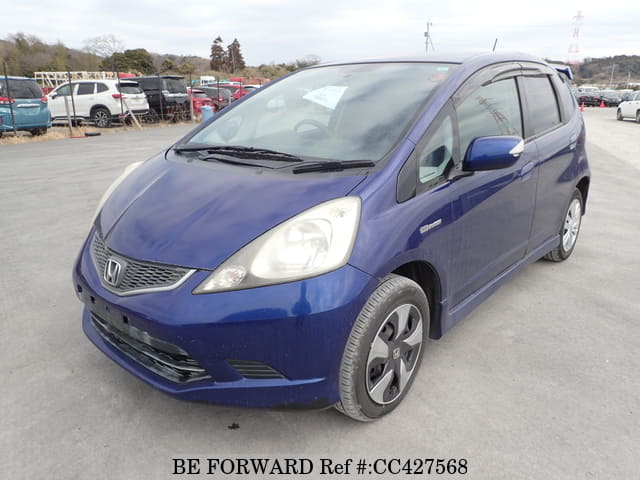 A grey JDM sports car speeding down a highway at night.