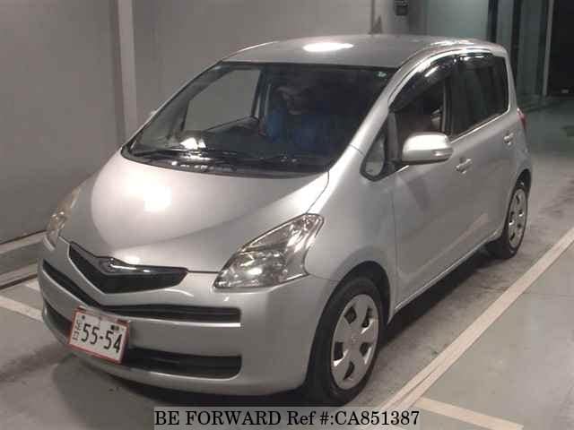 A grey JDM sports car speeding down a highway at night.