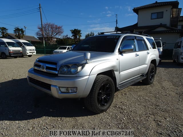 A grey JDM sports car speeding down a highway at night.